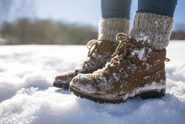 A pair of mountaineer's boots in the snow, close-up shot wearing men's compression socks