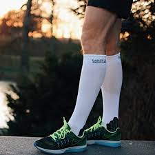 person standing in sports shoes after a run