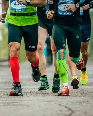 picture-of-athletes-running-on-road-wearing-compression-socks-sports-shoes