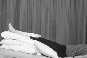 picture of a man with feet elevated,placed on pillows for relieving swollen feet 