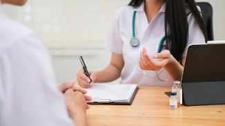 doctor prescribing treatment of men's knee high compression socks