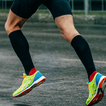 man-running-on-road-wearing-black-compression-socks