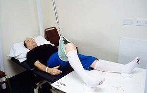 A patient lying in bed wearing white anti-thrombosis stockings