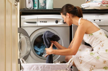 image of woman using a front-loading washer and dryer