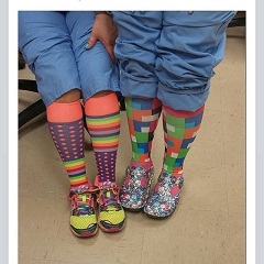 An image of two nurses wearing colorful compression hose