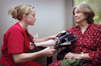 nurse checking blood pressure of patient, stethoscope