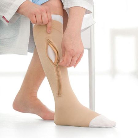 A patient wearing zip-up pressure socks with ease