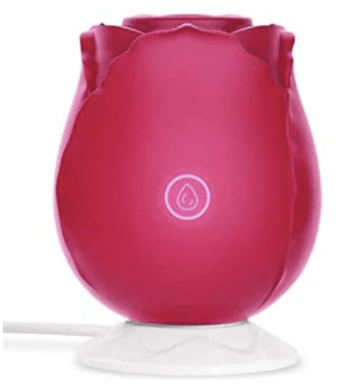 Picture of a rose toy on a wireless charger. The wireless charger allows the rose sex toy to be waterproof since there is no charging port.