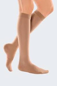 a woman wearing knee high 20 - 30 mmHg support womens compression socks