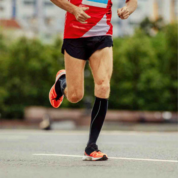 Man runnning wearing compression socks 