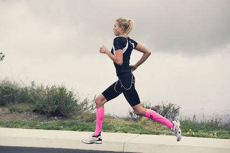 Athlete using compression socks during a run to prevent shin splints