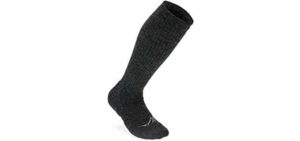 A black compression sock. Compression stockings that are knee high provide graduated compression from the foot to below the knee to prevent swelling and blood clots.