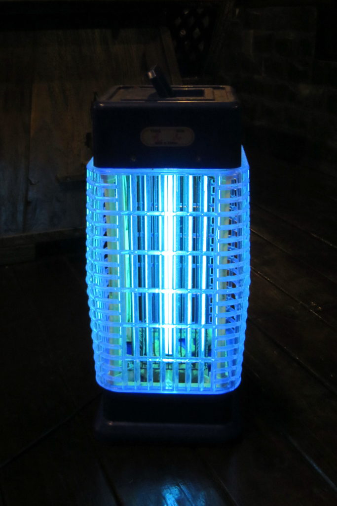 a small, black bug zapper that uses blacklight to attract mosquitoes and other insects