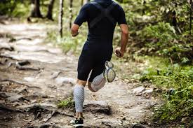 Image of a man running with compression stockings