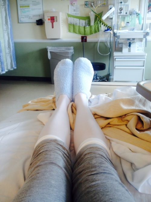 woman wearing compression socks in a hospital bed