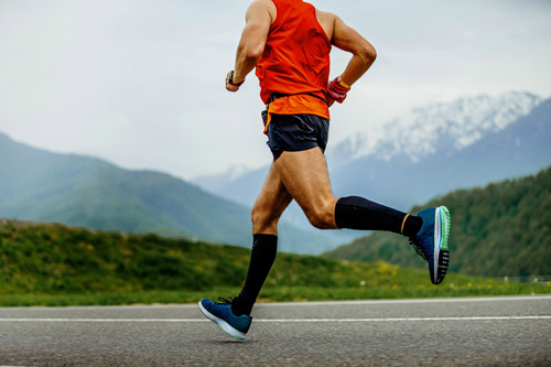 Man running, exercising with the best compression socks for edema