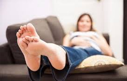 woman-with-lower-part-of-body-elevated-on-a-cushion-to-reduce-swelling