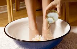 woman-with-feet-dipped-in-water-with-epsom-salt
