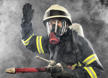 Firefighter in protective firefighting hazard equipment