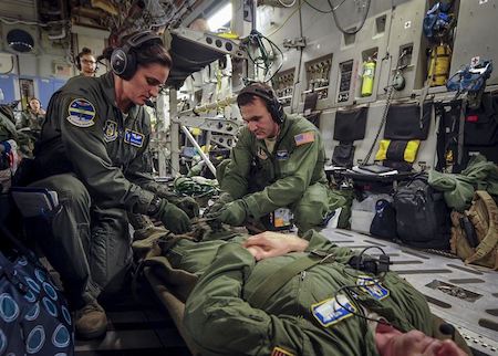 Military helping a patient.