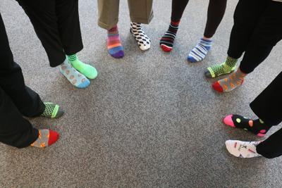 Group of people wearing multi-colored compression socks