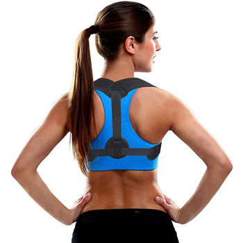 a woman in exercise clothes wearing a back brace and with her hands on her hips