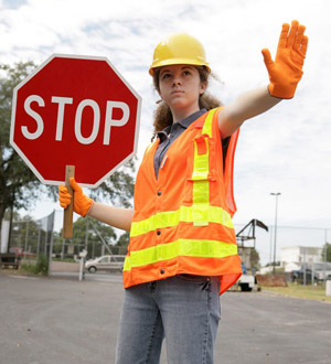 woman holding a stop sign