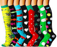 Several festive compression socks ranging from yellows and greens to strawberries and stripes.