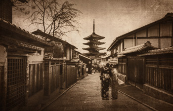 vintage photo of a street scene with 2 Japanese women posing in their traditional Japanese kimono