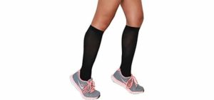 A person wearing a pair of black knee high compression stockings with a pair of shorts and athletic sneakers.