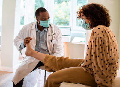 Doctor checking in on patient with Edema, swollen foot