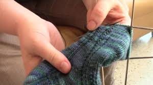 picture of person holding woolen socks 