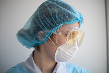 Person with N95 mask and protective goggles