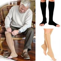 An old man on sleeves wearing a knee high zipped compression stockings for support