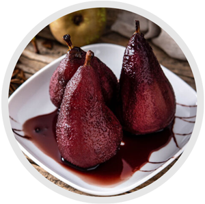 a dish of poached pears decorated with chocolate sauce and plated on a plain white plate