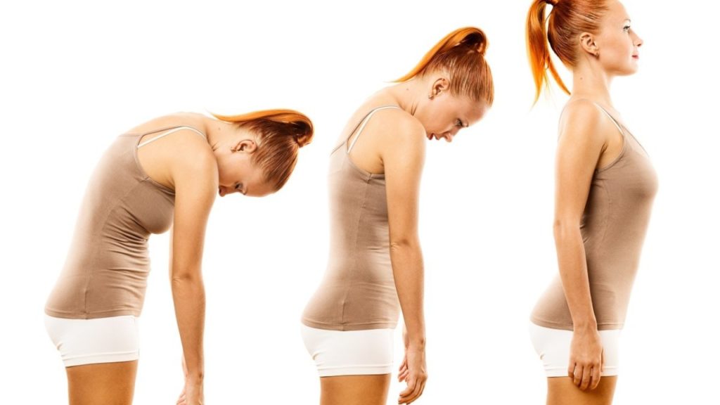 a woman in exercise gear shows how to move from her hunched position to standing up straight and tall