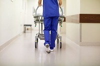 nurse caryying gurney to emergnecy room wearing knee high compression support socks