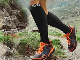 person running on mountains with compression socks