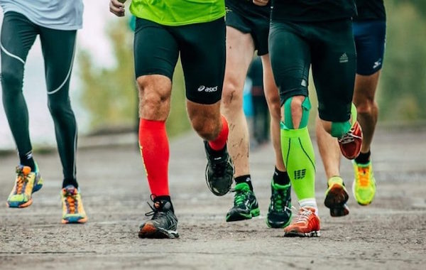 Men wearing compression socks to protect calf muscles while running
