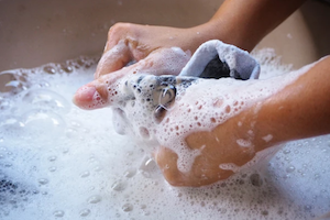 Bucket of soap water for washing compression socks