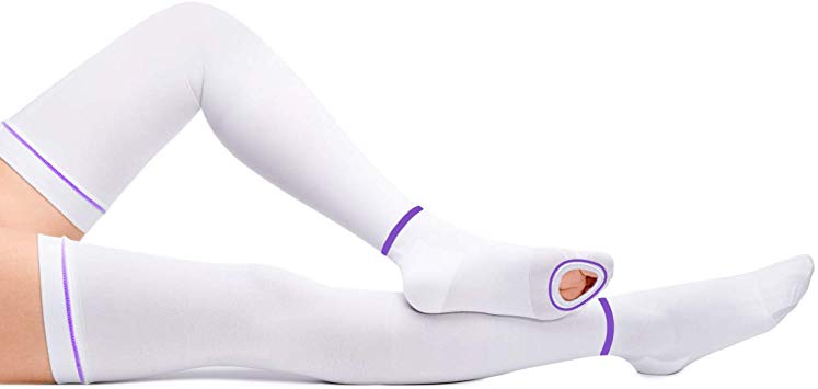 Image of a patient lieing down while wearing white tedhose socks