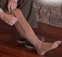GIF showing wearing brown compression sock and zipping it up.